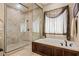 This bathroom features stylish tilework, a glass enclosed shower, and soaking tub at 1981 Trophy Elk Ave, Logandale, NV 89021