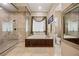 This bathroom features stylish tilework, a glass enclosed shower, and soaking tub at 1981 Trophy Elk Ave, Logandale, NV 89021