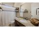 Bathroom featuring granite counter tops, dark cabinets, decorative mirror and shower curtain at 1981 Trophy Elk Ave, Logandale, NV 89021