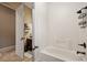 Bright bathroom featuring a bathtub with white tile surround and dark fixtures at 1981 Trophy Elk Ave, Logandale, NV 89021