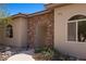 Charming home facade featuring a stone archway entrance and landscaped front yard at 1981 Trophy Elk Ave, Logandale, NV 89021