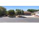 Spacious single-story home featuring a three-car garage, mature trees, and a well-maintained front yard at 1981 Trophy Elk Ave, Logandale, NV 89021