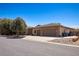 Exterior view showcasing the home's stone accents, three-car garage, and tile roof at 1981 Trophy Elk Ave, Logandale, NV 89021