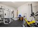 Home gym with rubber flooring, exercise equipment, storage racks, and bright lighting at 1981 Trophy Elk Ave, Logandale, NV 89021