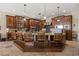 Spacious kitchen features an island with bar seating, custom cabinets, and stainless steel appliances at 1981 Trophy Elk Ave, Logandale, NV 89021