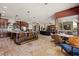 Spacious kitchen with custom cabinetry, an island with bar seating, and views of the living and dining areas at 1981 Trophy Elk Ave, Logandale, NV 89021