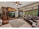 Cozy living room featuring a large entertainment center, comfortable seating, and ample natural light at 1981 Trophy Elk Ave, Logandale, NV 89021