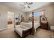 Relaxing main bedroom featuring carpet floors, a four-post bed, and an ensuite bathroom at 1981 Trophy Elk Ave, Logandale, NV 89021