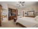Relaxing main bedroom featuring carpet floors, a four-post bed, built-in shelves and an ensuite bathroom at 1981 Trophy Elk Ave, Logandale, NV 89021