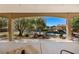 Covered patio overlooking a backyard oasis with a pool, rock features, and lush landscaping at 1981 Trophy Elk Ave, Logandale, NV 89021