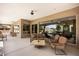 A covered patio boasts seating area and view into large window of home at 1981 Trophy Elk Ave, Logandale, NV 89021