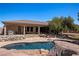 Spacious backyard with a large pool, rock waterfall, and mature trees, creating a private retreat at 1981 Trophy Elk Ave, Logandale, NV 89021