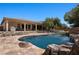 Beautiful pool with rock features, slide, and spa, perfect for outdoor entertaining at 1981 Trophy Elk Ave, Logandale, NV 89021