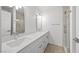 Modern bathroom with dual sinks, white cabinetry, and a tiled shower at 2080 Karen Ave # 60, Las Vegas, NV 89169