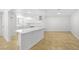 Bright, open kitchen with island cooktop, tile floors, and stainless steel hood at 2080 Karen Ave # 60, Las Vegas, NV 89169