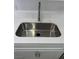 Close-up of the kitchen sink with white countertop and stainless steel pull-down faucet at 2080 Karen Ave # 60, Las Vegas, NV 89169