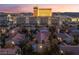 Aerial view of a residential community with a swimming pool and sunset at 2615 W Gary Ave # 2013, Las Vegas, NV 89123