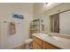Bright bathroom features a shower with tan tiling and a light wood vanity at 2615 W Gary Ave # 2013, Las Vegas, NV 89123