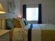 Comfortable bedroom with a queen bed, decorative pillows, and a large window at 2615 W Gary Ave # 2013, Las Vegas, NV 89123