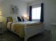 Comfortable bedroom with a queen bed, decorative pillows, and a large window at 2615 W Gary Ave # 2013, Las Vegas, NV 89123