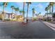 A gated community entrance with lush landscaping and mature palm trees creates a welcoming environment at 2615 W Gary Ave # 2013, Las Vegas, NV 89123