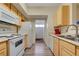 Galley kitchen boasts white appliances and light wood cabinets with plenty of storage at 2615 W Gary Ave # 2013, Las Vegas, NV 89123