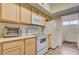 Cozy kitchen equipped with white appliances and lots of light wood cabinet storage at 2615 W Gary Ave # 2013, Las Vegas, NV 89123