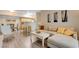 Open-concept living room with wood floors, comfortable seating, modern decor, and a dining area at 2615 W Gary Ave # 2013, Las Vegas, NV 89123