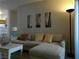 Cozy living room featuring a plush sectional sofa, stylish decor, and ample natural light creating a comfortable living space at 2615 W Gary Ave # 2013, Las Vegas, NV 89123