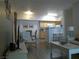 Bright open-concept living area with neutral tones, laminate flooring, and a view into the dining area and well-equipped kitchen at 2615 W Gary Ave # 2013, Las Vegas, NV 89123