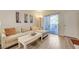 Comfortable living room with wood floors, a sectional sofa, and sliding doors to the outside balcony at 2615 W Gary Ave # 2013, Las Vegas, NV 89123