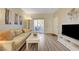 Inviting living room features a light sofa, sliding glass door, and wood-look flooring at 2615 W Gary Ave # 2013, Las Vegas, NV 89123