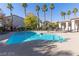 Community pool with lounge chairs and shade structures amid palm trees at 2615 W Gary Ave # 2013, Las Vegas, NV 89123