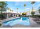 Community pool area with clear water, surrounded by palm trees and lounge chairs at 2615 W Gary Ave # 2013, Las Vegas, NV 89123