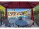 Covered outdoor seating area with a view of the community pool at 2615 W Gary Ave # 2013, Las Vegas, NV 89123