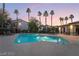 Community pool at dusk with lounge chairs and a cabana at 2615 W Gary Ave # 2013, Las Vegas, NV 89123