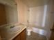 Bright bathroom with a single sink vanity and combined tub and shower at 2685 Bryandouglas Dr, Las Vegas, NV 89121