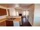 Open kitchen with wood cabinets, bright countertops and open view to the living area at 2685 Bryandouglas Dr, Las Vegas, NV 89121