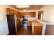 A kitchen with wooden cabinets, stainless steel appliances, and a breakfast bar at 2685 Bryandouglas Dr, Las Vegas, NV 89121