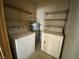 Laundry room including shelving, a water heater, washer, and dryer at 2685 Bryandouglas Dr, Las Vegas, NV 89121