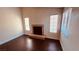 Cozy living room featuring a fireplace, two windows, and dark hardwood floors at 2685 Bryandouglas Dr, Las Vegas, NV 89121
