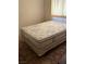 A basic bedroom with neutral tones highlighting a bed with a patterned mattress and cream colored walls at 2724 Natalie Ave, Las Vegas, NV 89121