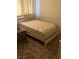 A bedroom with a neutral interior and natural light showing a white bed with an upholstered mattress at 2724 Natalie Ave, Las Vegas, NV 89121