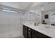 Bathroom featuring tiled floors, dual sinks, modern fixtures, and a glass-enclosed shower at 2827 Turnstone Ridge St, Henderson, NV 89044