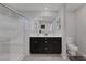 Bathroom featuring tiled floors, dual sinks, modern fixtures, and a glass-enclosed shower at 2827 Turnstone Ridge St, Henderson, NV 89044
