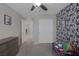 Bedroom features whimsical wallpaper, neutral walls, carpeted floor, and closet space at 2827 Turnstone Ridge St, Henderson, NV 89044