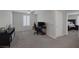 Spacious bedroom with neutral walls, ceiling fan, and carpet floors, featuring a work area at 2827 Turnstone Ridge St, Henderson, NV 89044