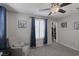 Bedroom featuring neutral walls, gray carpeting, ceiling fan, framed art, and open closet for storage at 2827 Turnstone Ridge St, Henderson, NV 89044