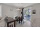Dining area with modern lighting and furniture adjacent to a bright, open living space at 2827 Turnstone Ridge St, Henderson, NV 89044