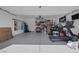 Spacious garage with epoxy flooring, white walls, storage shelving, and a home gym at 2827 Turnstone Ridge St, Henderson, NV 89044
